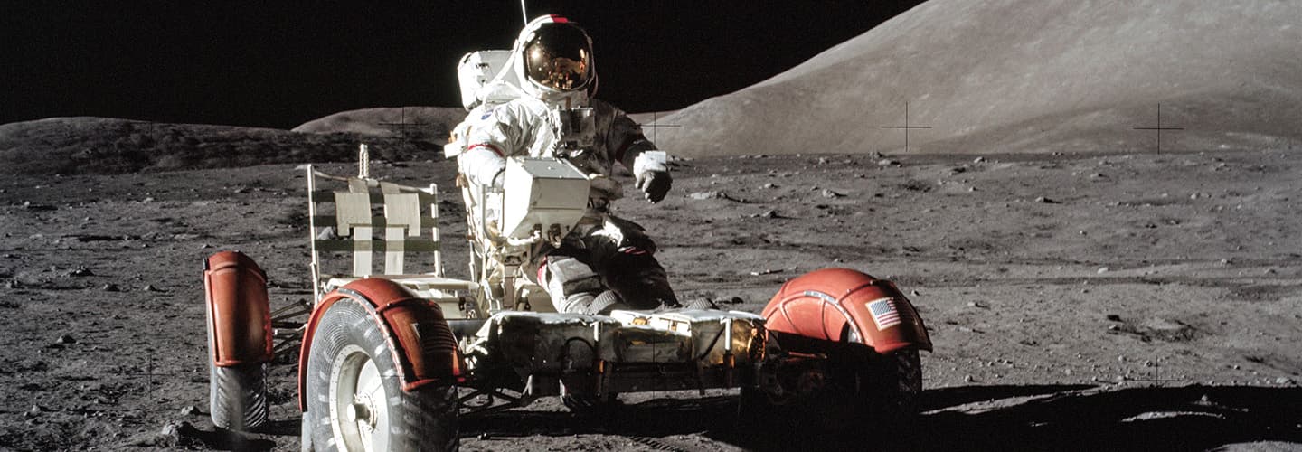 Image of an astronaut riding a moon rover on the moon