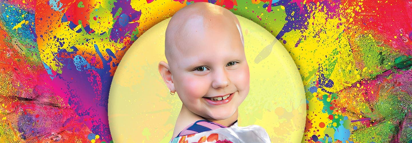 Photo of a smiling child in front of a colorful background