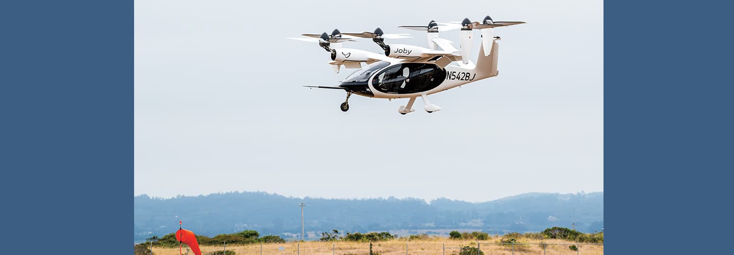 Photo of a helicopter flying over land