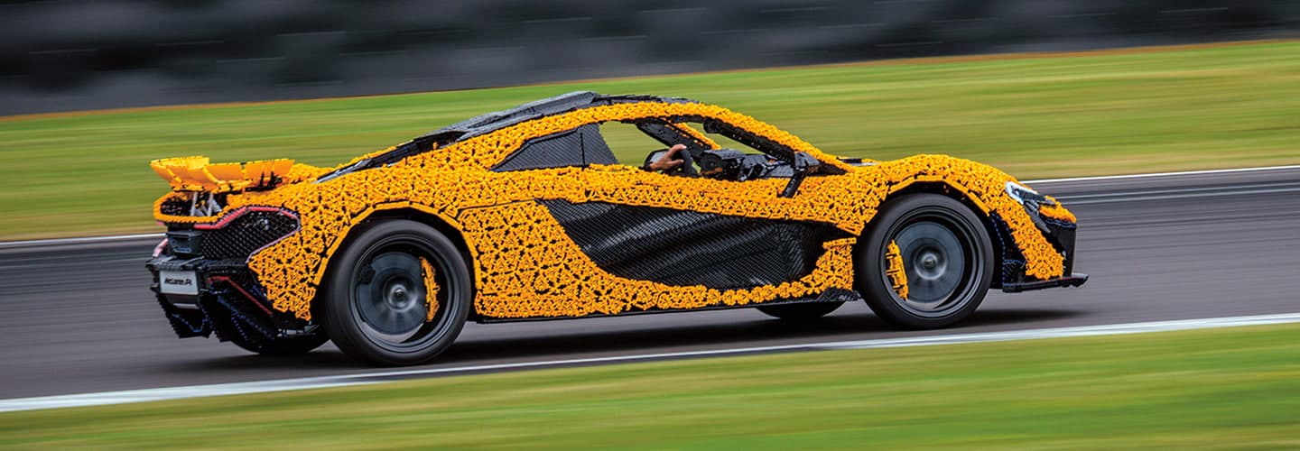 a car made out of yellow and black LEGO pieces