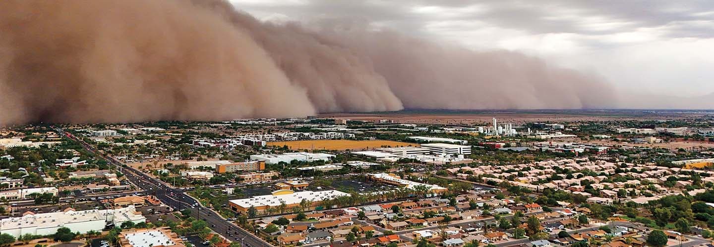 Bird's eye view of a dust storm passing over a city